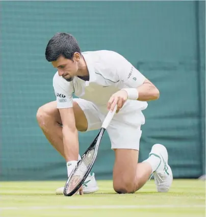  ?? ALASTAIR GRANT/AP ?? Novak Djokovic gets up after slipping on the grass during his second-round victory over Kevin Anderson on Wednesday.