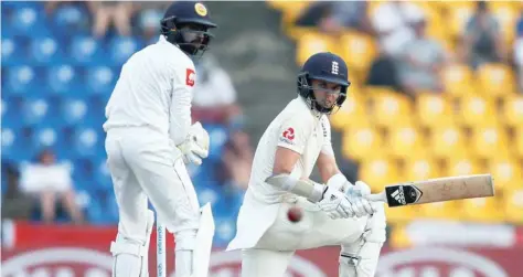  ?? — Reuters ?? England’s Sam Curran (R) hits a boundary next to Sri Lanka’s wicketkeep­er Niroshan Dickwella.