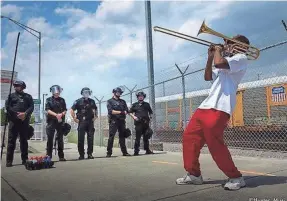  ?? COURTESY OF MARCUS MCDONALD ?? Black Lives Matter activist Marcus McDonald plays his trombone at a recent protest in Charleston, South Carolina.