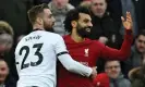  ?? Paul Ellis/AFP/Getty Images ?? Luke Shaw takes drastic measures to try and contain Mohamed Salah. Photograph: