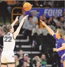  ?? MATTHEW PUTNEY / ASSOCIATED PRESS ?? Iowa guard Caitlin Clark (22) shoots a 3-pointer over Holy Cross guard Simone Foreman during Saturday’s NCAA Tournament game in Iowa City, Iowa.