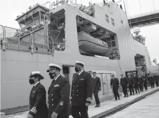  ?? TIM KROCHAK • THE CHRONICLE HERALD ?? Crew members of the future HMCS Margaret Brooke prepare to board the ship after it was given over at a ceremony at HMC Dockyard on Thursday.