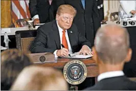  ?? ALEX WONG/GETTY IMAGES ?? President Donald Trump on Monday signs an executive order to establish “Space Force.”