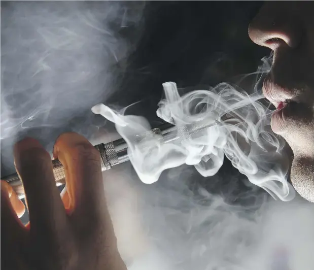  ?? DAN KITWOOD / GETTY IMAGES ?? Vaping is “clearly something that needs regulation,” a Canadian Cancer Society official says. “We don’t want kids to be using these cigarettes.”