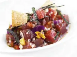  ?? Debora Smail ?? Yellowfin tuna poke with tomato, citrus-soy, red onion, cilantro and toasted nori is on the menu at Peska Seafood Culture. Kata Robata, Gyu-Kaku Japanese BBQ, Mo’s Steakhouse, Killen’s and Shade serve poke dishes as well.