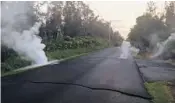  ??  ?? Steam rises from a fissure in a street Friday in the Leilani Estates subdivisio­n near Pahoa, Hawaii, after the eruption of the Mount Kilauea volcano following an earthquake.