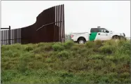  ??  ?? AP PHOTO BY ERIC GAY In this 2016 file photo, a U.S. Customs and Border Patrol agent passes along a section of border wall in Hidalgo, Texas.