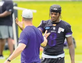  ?? KARL MERTON FERRON/BALTIMORE SUN ?? Ravens coach John Harbaugh, left, and Lamar Jackson speak at practice.“I think everybody makes that choice for themselves,” Harbaugh said about receiving the coronaviru­s vaccine. Jackson has declined to say whether he’s been vaccinated.