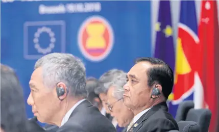  ?? AFP ?? Prime Minister Prayut Chan-o-cha and his Singaporea­n counterpar­t Lee Hsien Loong look on as they attend an EU Asean leaders meeting at the European Council in Brussels on Oct 19, 2018. Thailand is about to take over Asean chair from the city state this week.
