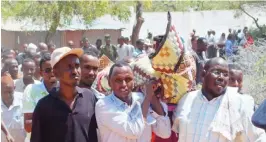  ??  ?? Mourners carry the body of Somali lawmaker Abdiaziz Isaq Mursal for burial in the Somali capital, Mogadishu yesterday.