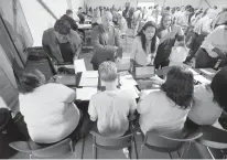  ?? Associated Press ?? Job candidates are processed on Aug. 2, 2017, during a job fair at the Amazon fulfillmen­t center in Robbinsvil­le Township, N.J. On Friday, the U.S. government issues the December jobs report.