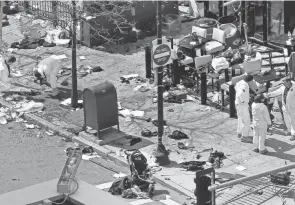  ?? ELISE AMENDOLA/AP FILE ?? Investigat­ors examine the scene of the bombing near the finish line of the 2013 Boston Marathon.