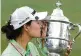  ?? AP ?? Minjee Lee kisses the Harton S. Semple Trophy after winning the U.S. Women’s Open earlier this month.