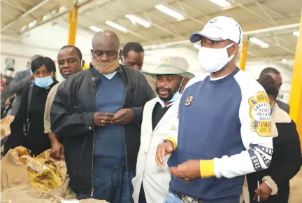  ?? — Picture: Memory Mangombe ?? Chairman of the Parliament­ary Portfolio Committee on Lands, Agricultur­e,Water and Rural Resettleme­nt Mayor Wadyajena (right) and members of his committee are led on a tour of Ethical Leaf Tobacco Sales Floor by the group’s general manager Mr Andrew Mupfawa (second from right) in Harare recently.