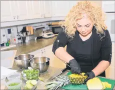  ?? MITCH MACDONALD/THE GUARDIAN ?? Chef Ilona Daniel hollows out a pineapple to help give a shrimp fried rice dish a tropical theme. If you don’t want to hollow out a pineapple, the dish can also be served in a regular bowl with pineapple spears or chunks diced into smaller pieces.