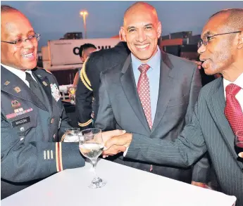  ?? PHOTO BY CHRISTOPHE­R SERJU ?? Commission­er of Police Major General Antony Anderson (Centre) is clearly enjoying himself as Major Baron Mason (left), special security officer with the District of Columbia Army National Guard, greets Major General Rocky Meade, chief of defence staff, during yesterday’s reception on the US Coast Guard ‘Cutter Resolute’, hosted by the United States Embassy.