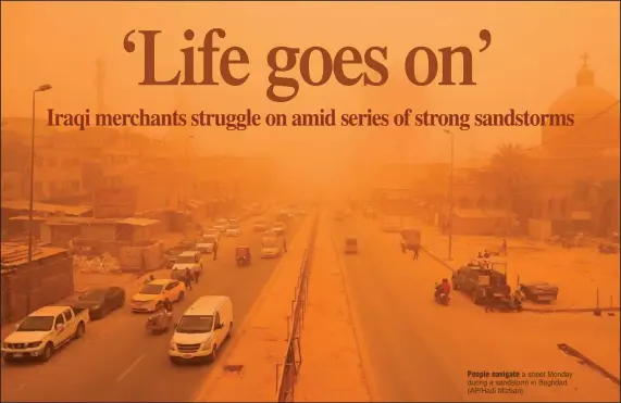  ?? ?? People navigate a street Monday during a sandstorm in Baghdad. (AP/Hadi Mizban)