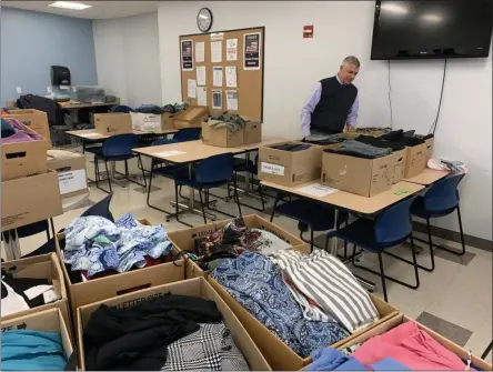  ?? SUBMITTED PHOTO ?? Oneida County Executive Anthony Picente looks over work attire donated for the OneidaWork­s! career event on Thursday, Oct. 17, 2019.