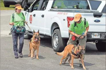  ?? Jeremy stewart ?? Members of Randall’s Adventure and Training Search and Rescue, a nonprofit regional search and rescue agency based in Gallant, Ala., return to the staging area at Dugdown Baptist Church after checking an area for Barbara McCray on Monday, Aug. 2.