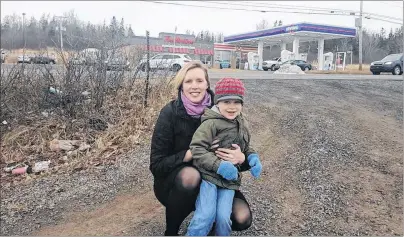  ?? PHOTO SUBMITTED/JENNIFER ANDERSON ?? Jennifer Anderson and her son Anderson Green kneel down near the end of their driveway, located directly across from the Irving/Tim Hortons location on Highway 105 in Baddeck. Jennifer Anderson has concerns about constructi­on scheduled for the area...