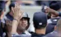  ?? JULIE JACOBSON — THE ASSOCIATED PRESS ?? Yankees’ Gleyber Torres celebrates with teammates after scoring on a throwing error by the Cleveland Indians during the fifth inning of Saturday’s game.