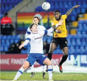  ??  ?? Rovers midfielder Abu Ogogo wins a header against Tranmere