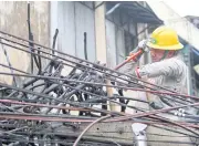  ?? APICHART JINAKUL ?? A power pole is being repaired on Bamrung Muang Road in Bangkok. Monthly electricit­y bill for the SeptemberD­ecember period is expected to rise to 3.59 baht per unit.