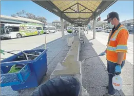  ?? SHERRY LAVARS — MARIN INDEPENDEN­T JOURNAL ?? Kenneth Rodriguez of Golden Gate Transit sprays a bench with disinfecta­nt at the downtown transit center in San Rafael on Friday.