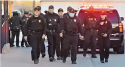  ?? JIM THOMPSON/JOURNAL ?? State Police escort their fallen colleague to a Deming funeral home on Thursday evening.