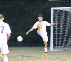  ?? STAFF PHOTO BY JOHN NISWANDER ?? McDonough senior Quinlan Robertson attempts to clear the ball out of the Rams’ defensive zone during the first half of Tuesday night’s 5-2 win at Lackey in a 1A South Region Section II semifinal game.