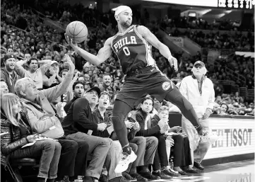  ??  ?? Philadelph­ia 76ers guard Jerryd Bayless leaps into the stands in an effort to save a ball headed out of bounds during the second quarter against the Los Angeles Lakers at Wells Fargo Center. — USA TODAY Sports photo