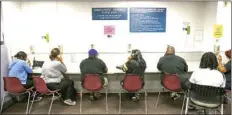  ?? AP PHOTO/RICH PEDRONCELL­I ?? In this Sept. 20 2013 file photo, visitors use the Unemployme­nt Insurance phone bank at the California Employment Developmen­t Department, EDD office in Sacramento, Calif.