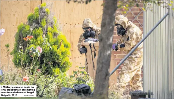  ?? Adam Gerrard ?? Military personnel begin the long, arduous task of removing items from the home of Sergei Skripal in 2018