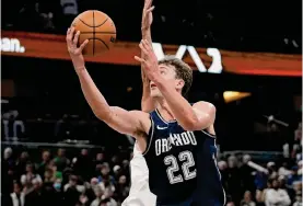  ?? John Raoux/associated Press ?? Orlando Magic forward Franz Wagner and his brother Moritz combined for 44 points in a 113-96 win over the Eastern Conference-leading Boston Celtics.