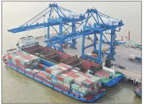  ?? (AP/Chinatopix) ?? Two container ships sit docked at a port last week on the Yangtze River in Nantong in eastern China’s Jiangsu province. China’s exports were up in March compared with a year ago.