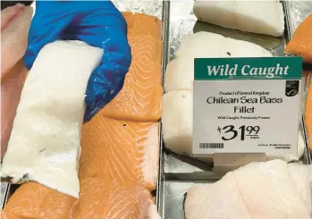  ?? JOSHUA GOODMAN/AP ?? Fillets of Chilean sea bass caught near the U.K.-controlled island of South Georgia are offered for sale last week at a Whole Foods Market in Cleveland, Ohio. The species is at the center of a diplomatic row between the U.S. and U.K.