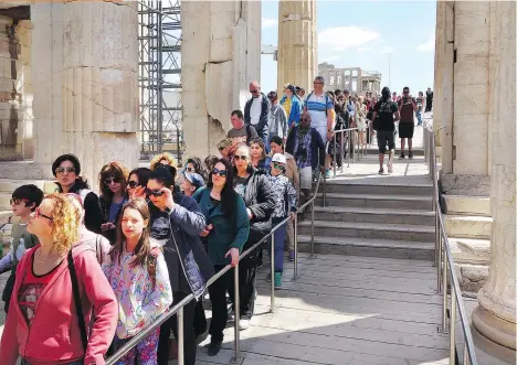  ?? RICK STEVES ?? In Athens, cruise passengers line up in the Parthenon. Arrive at tourist sites late in the afternoon to avoid the usual midday rush.