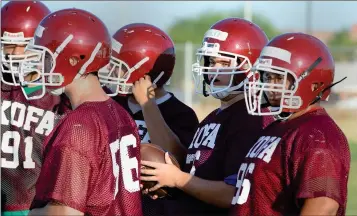  ?? BUY THIS PHOTO AT YUMASUN.COM
PHOTO BY RANDY HOEFT/ YUMA SUN ?? KOFA JUNIOR ANTHONY WOLFF (WITH BALL) AND HIS TEAMMATES WAIT for the next offensive play to be called in the huddle during a Kings’ practice Friday morning. Wolff is penciled in as the Kings’ starting center in 2015.