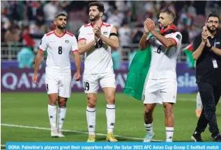  ?? — AFP ?? DOHA: Palestine’s players greet their supporters after the Qatar 2023 AFC Asian Cup Group C football match between Hong Kong and Palestine at the Abdullah bin Khalifa Stadium in Doha.