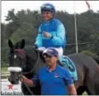  ?? DAVID M. JOHNSON — DJOHNSON@ DIGITALFIR­STMEDIA.COM ?? Miss Ella and jockey Joel Rosario are led into the winner's circle after winning The Caress Stakes Monday at Saratoga Race Course.