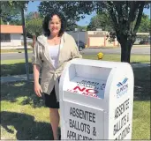  ?? MEDIANEWS GROUP FILE PHOTO ?? Clinton Township Clerk Kim Meltzer stands next to a drop-off box available to voters who need to handdelive­r their absentee ballot, earlier this year.