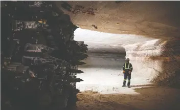  ?? JAMES MACDONALD/BLOOMBERG FILES ?? A miner stands near a mining wall at the Nutrien potash mine in Saskatoon. The fate of many mines may rest on whether Australian rival BHP builds its Jansen potash project.