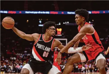  ?? Tim Warner/Getty Images ?? Friday’s game between the Rockets and the Trail Blazers will pit Portland’s Scoot Henderson, left, against Amen Thompson in a matchup between the No. 3 and No. 4 overall picks in last year’s NBA draft.