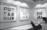  ?? PAN YULONG / XINHUA ?? Students look at exhibits about the history of China’s national anthem at an exhibition in Shenyang, Liaoning province, in April last year.