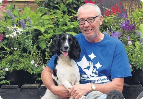  ??  ?? Jimmy Church clutches his devoted ‘Bravehound’, which has helped him come to terms with PTSD.