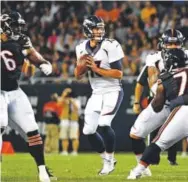  ??  ?? Second-year Broncos quarterbac­k Trevor Siemian looks for a passing lane in the preseason opener against the Bears in Chicago. Joe Amon, Denver Post file