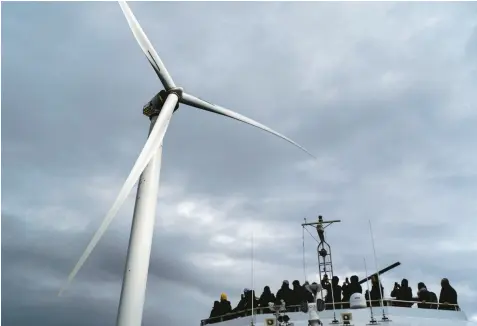  ?? DAVID GOLDMAN/AP ?? Guests tour one of the turbines of America’s first offshore wind farm, owned by the Danish company Orsted, on Oct. 17 off the coast of Block Island, R.I. A new poll shows many think not enough is being done to fight climate change.