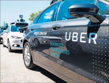  ?? Angelo Merendino AFP/Getty Images ?? AS THE COST of ride-hailing services falls because they no longer need to pay drivers, people who now take the bus or subway will instead opt for door-to-door service. Above, an Uber self-driving car in Pittsburgh.