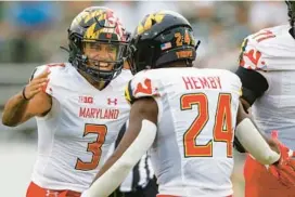  ?? NELL REDMOND/AP ?? Maryland quarterbac­k Taulia Tagovailoa, left, and running back Roman Hemby celebrate during a win over Charlotte on Saturday. Last season, Tagovailoa set single-season program records in passing yards (3,860), completion­s (454) and completion rate (69.2%) while leading Maryland to its first bowl victory since 2010.