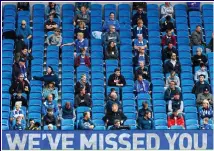  ??  ?? MIND THE GAP: Fans had to wear face masks outside the ground but were able to remove them after taking to their socially-distanced seats